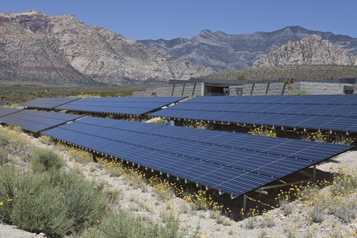 An expansive amount of solar panels lay on top of the landscape of the Sonoran desert.