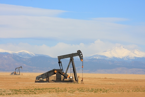 A view at a large oil extracting machine in the middle of the Mexican landscape.