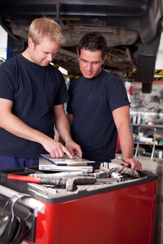 Two men talking about different ways to solve the skilled labor shortage problem that BMW encountered.