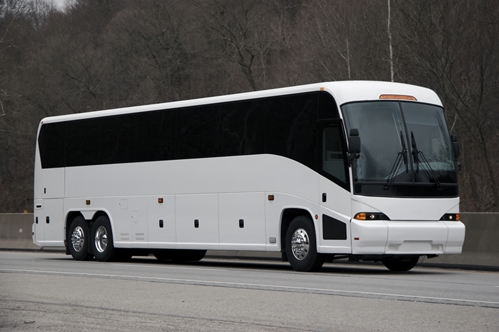 A picture of a huge bus that is traveling on a highway.