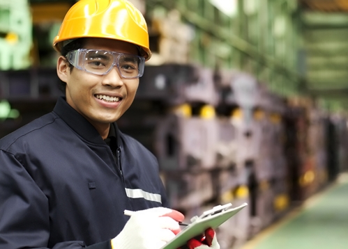 Mexican employee, happily working in a manufacturing facility in Mexico.