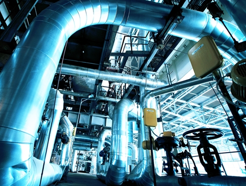 A very large manufacturing plant showing many large blued air ducts and complex infrastructure.