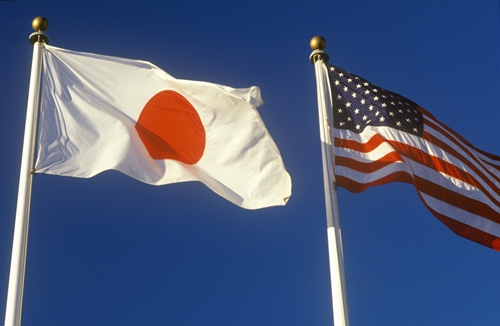 I view od two flags waving in the sky: The japanese flag, and the American flag.