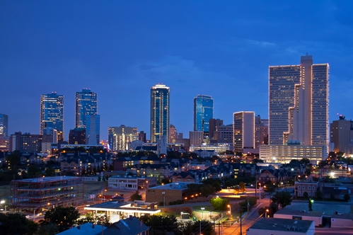 A view at a large city filled with bright skyscrapers.