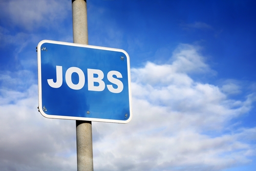 A sign saying jobs in large white letters with a blue background, and a clear blue sky is the overall background.