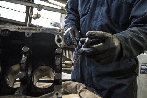 A skilled laborer in Mexico works to help produce a large metal object.