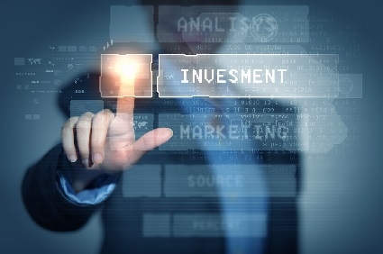 A man touching a screen satating investment as the boldest term.
