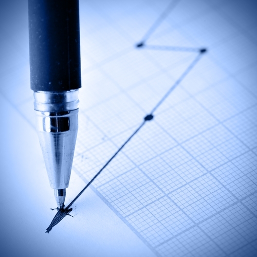 A pen marking a black line on the tail end of a graph.