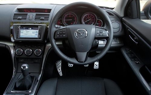 A look inside a Mazda vehicle from the perspective of the driver's seat.