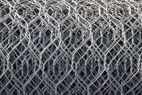 A picture of a plentiful amount of mesh wire in the shape of a fence.