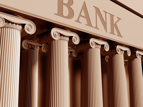 A large building with greek pillars and a large heading stating "Bank".