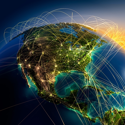 Light connecting many different brightly lit cities across the world.
