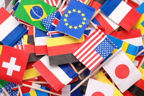 A large collage of flags from all over the world including the U.S. flag, the Japanese flag, the French flag, etc.