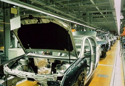 An automobile manufacturing facility in Mexico is constructing the hood of an automobile