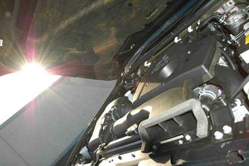 A look inside the hood of a mitsubishi.
