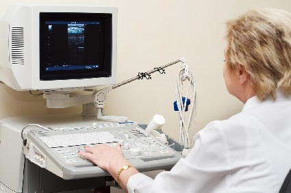 A female doctor analyzing something on a medical device that was manufactured in Mexico.