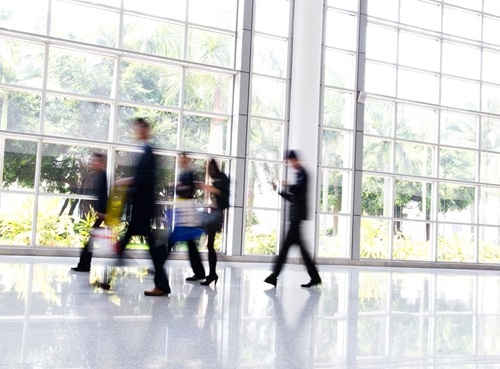 There is a large room filled with natural sunlight as well as hard working professionals ready to go to work.