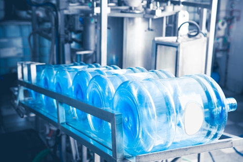 A factory holds several large plastic water jugs.
