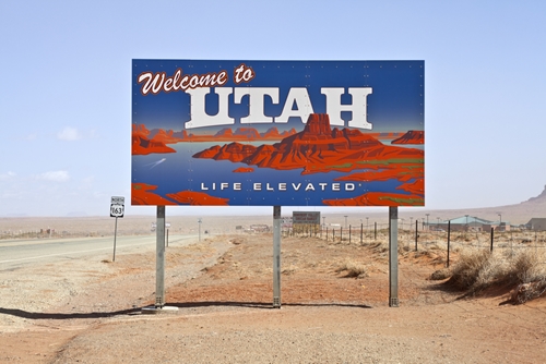 A billboard on the side of the road saying "Welcome to Utah"