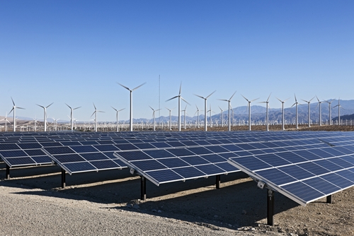 A picture of renuable energy being used for a manufacturing factory in the form of solar panels.